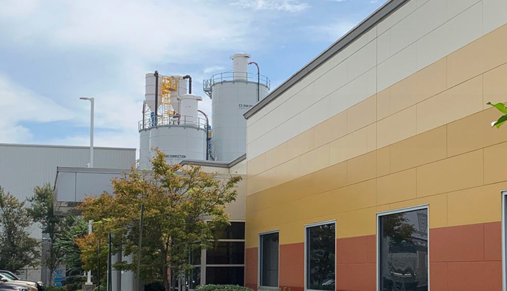 Exterior of a Nichiha facility clad in tan and orange fiber cement panels