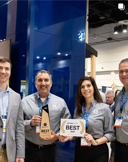 Four team members holding Nichiha's BIMsmith Best of 2026 award at the booth