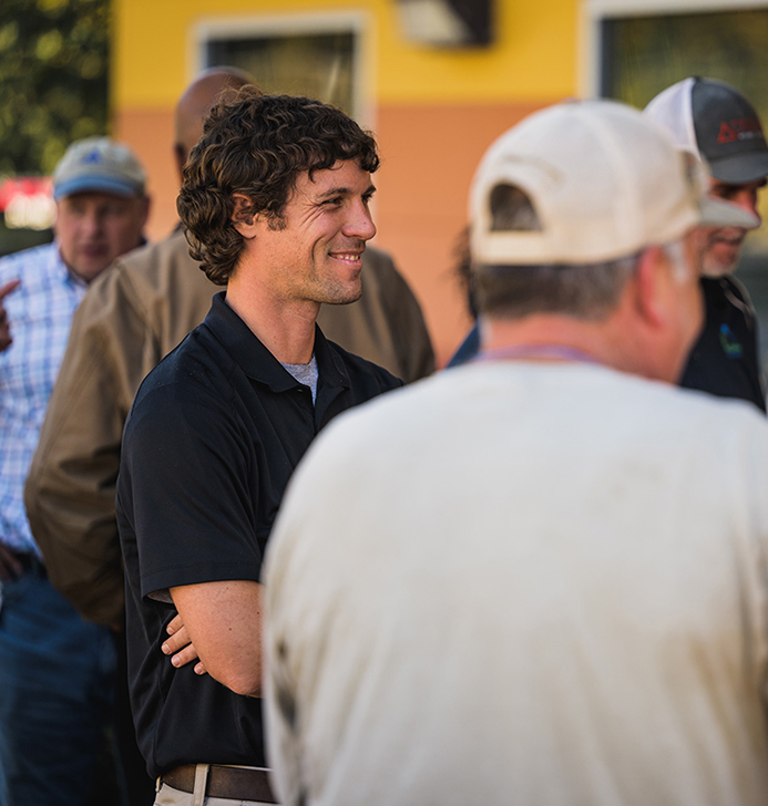 A Nichiha team member talking with contractors outside a recently clad building
