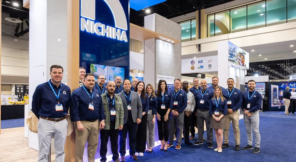 The Nichiha USA team gathered in front of the company's trade show booth