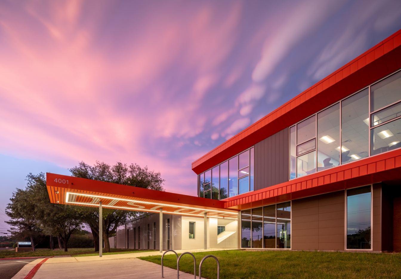 School exterior with red wall panels at dusk