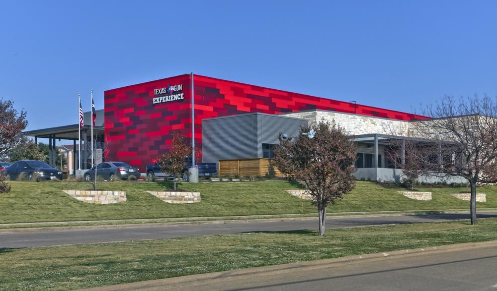 This shooting range in Texas has red fiber cement siding on the exterior.