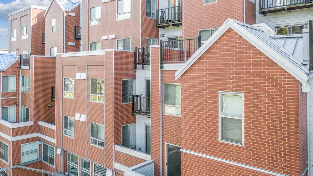 A multi-family building with red brick and white trim.