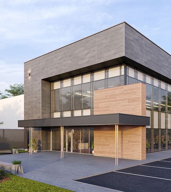 The exterior of a modern-style office building with gray fiber cement block panels surrounding tall windows and a wooden wall.