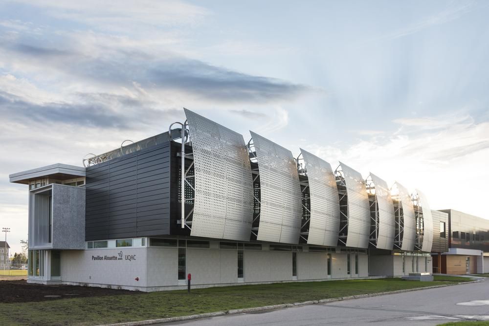 A convention center with concrete aesthetic cladding from Nichiha&rsquo;s fiber cement cladding product line. Large, steel, rounded panels stick out from the sides.