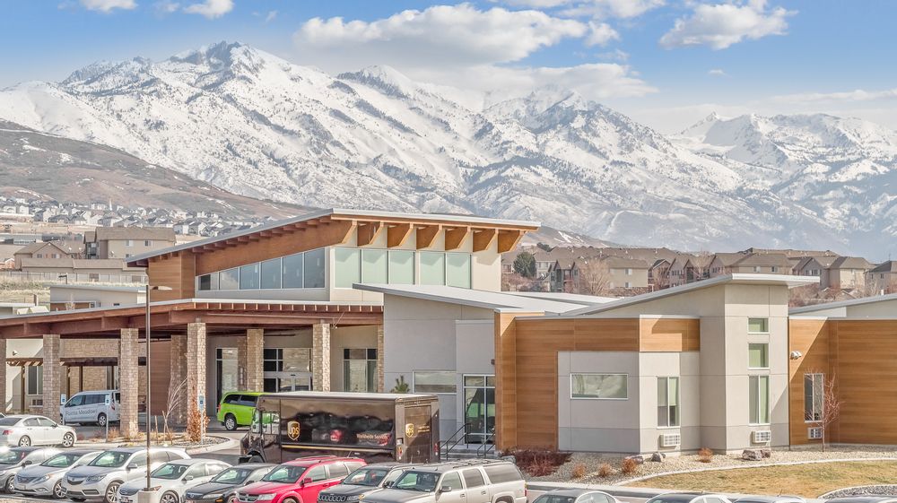 A faraway shot of Lehi Skilled Nursing Facility in Utah utilizing Nichiha&rsquo;s EmpireBlock fiber cement cladding in gray and VintageWood fiber cement cladding.