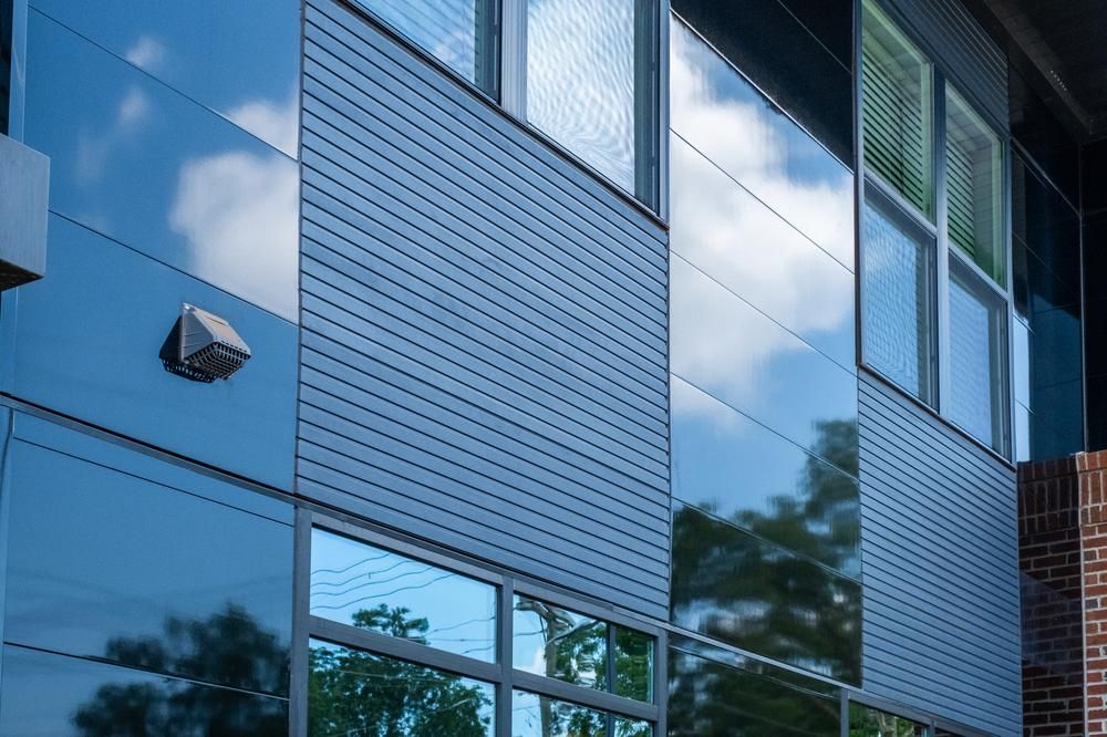 The exterior of an apartment building utilizing Nichiha Miraia and Ribbed fiber cement cladding.