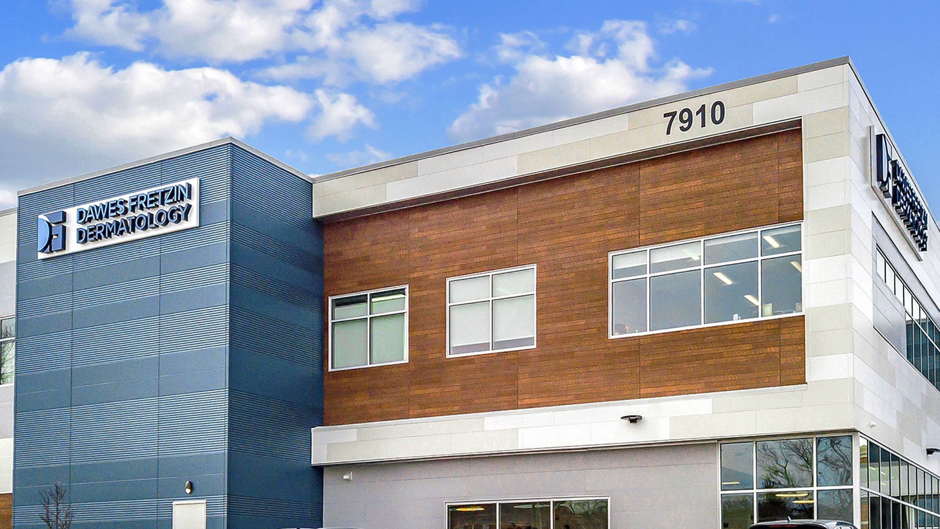 The exterior of an apartment complex utilizing blue, cedar and brick Nichiha fiber cement cladding.