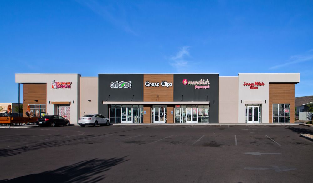 A retail strip mall housing Dunkin Donuts, Cricket, Great Clips, Menchie’s and Jersey Mikes. The exterior walls are utilizing Nichiha’s fiber cement cladding. Blue skies are behind it.