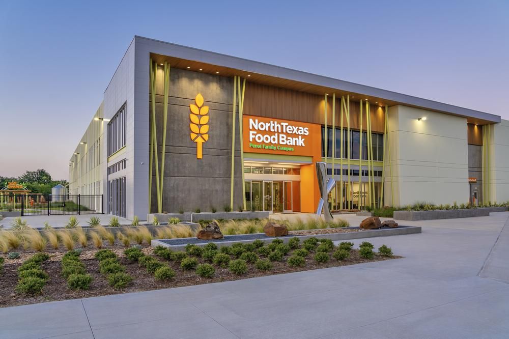 North Texas Food Bank commercial building with Nichiha&rsquo;s fiber cement cladding with a branded orange entrance.