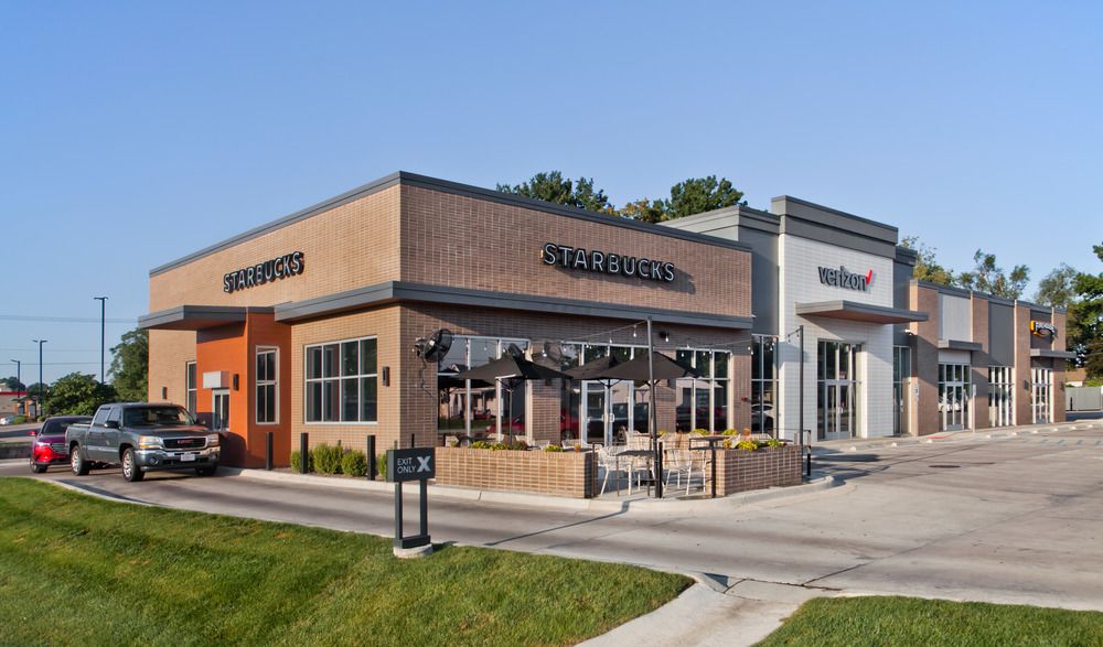 The corner of the Brentwood Plaza strip mall housing Starbucks, Verizon and Firehouse Subs utilizing Nichiha’s fiber cement cladding. There is a truck in the Starbucks drive through.