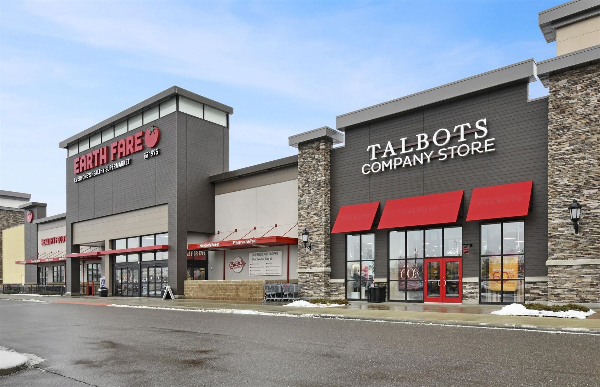 Nichiha-Illumination-VinatageWood-Commercial, Shopping center store fronts of a Earth Fare and Talbots that use Nichiha’s VintageWood panels in the color Bark