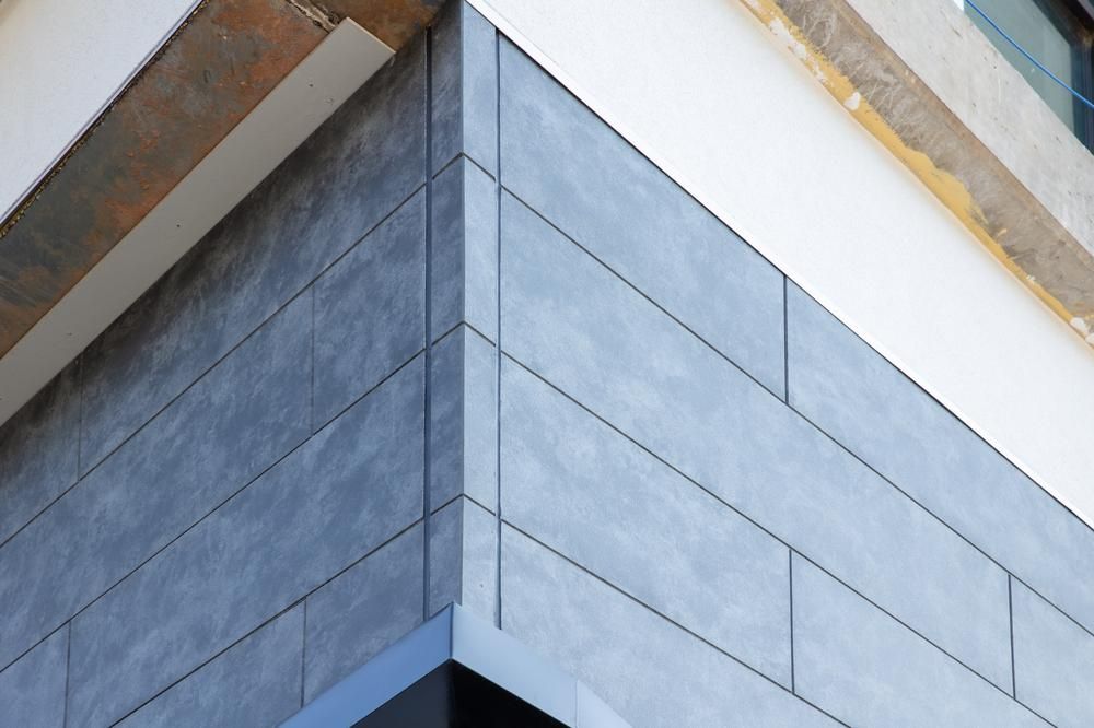 Close-up of blue, stone-look fiber cement siding on the corner of a home.