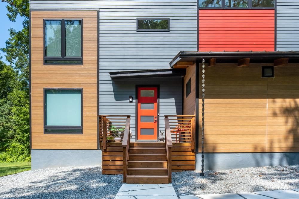 A brown, grey, and red home decorated in Nichiha&rsquo;s fiber cement siding.
