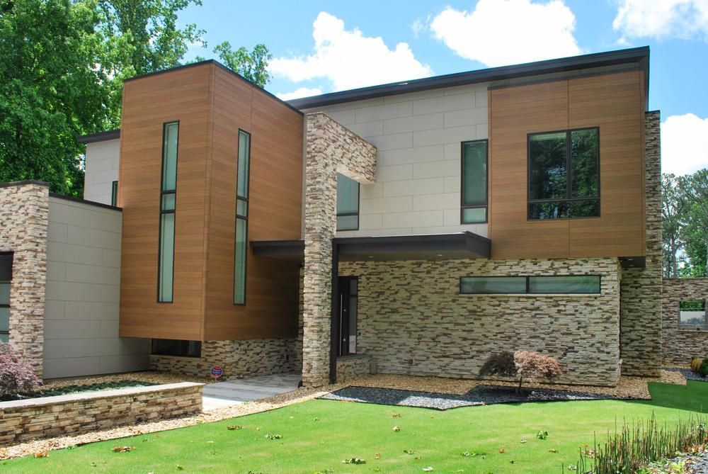 A two-story modern style home with sections of cedar and light gray fiber cement siding.