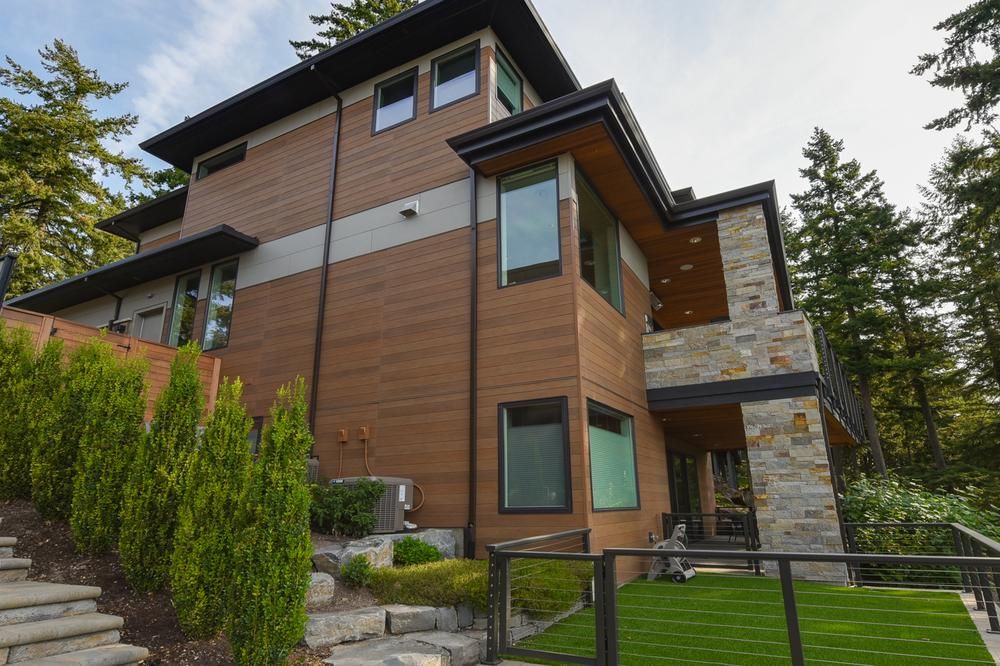 A modern home with fiber cement siding and a small fenced in yard.
