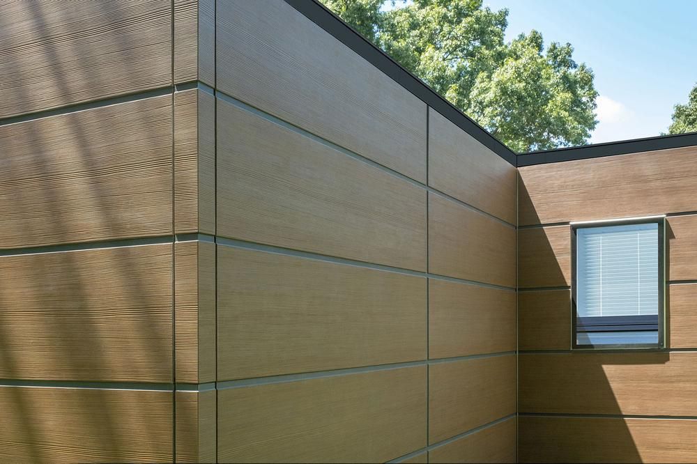 Exterior of home with lightly colored wood look fiber cement paneling.