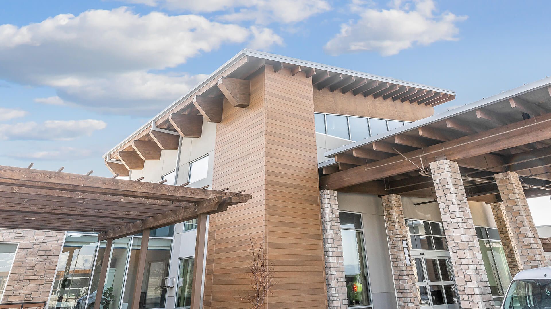 Nichiha-VintageWood-Cedar-Commercial, Corner of commercial building that features Nichiha’s VintageWood panels in the color Cedar